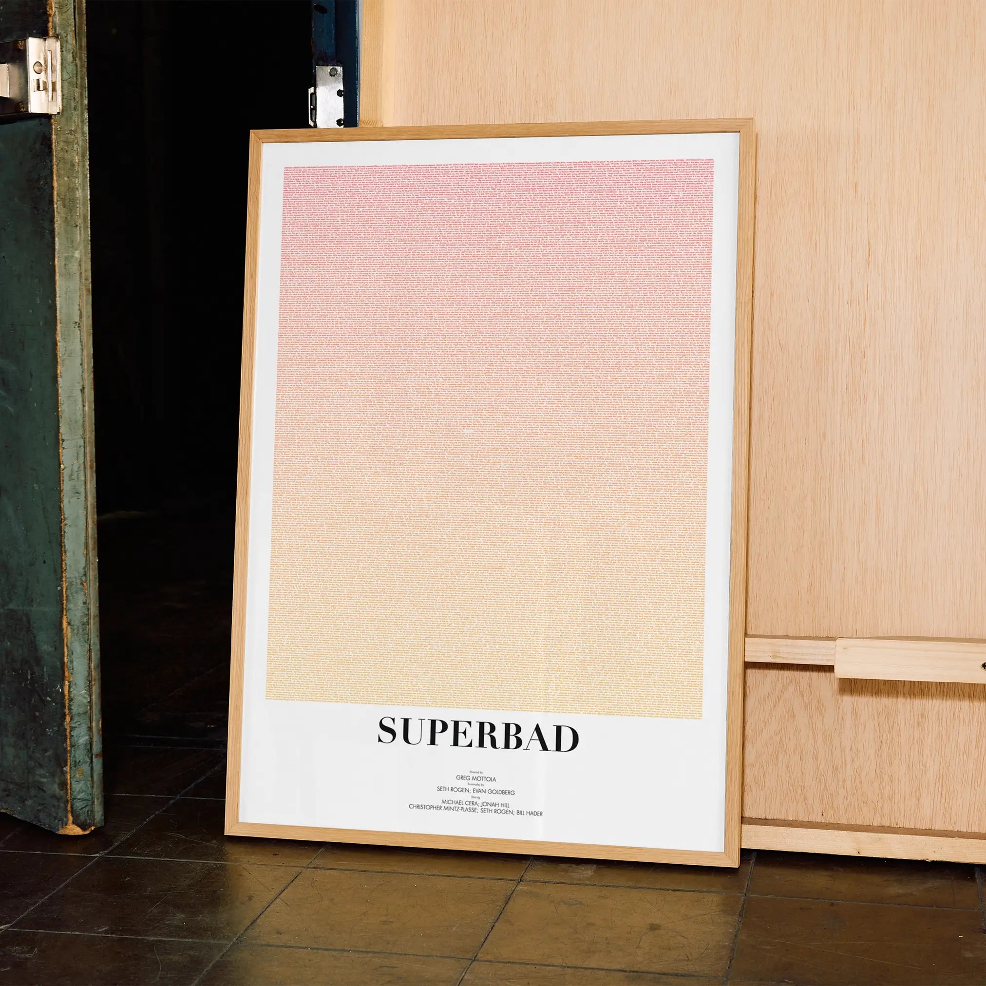 A framed Superbad movie script poster displayed in a contemporary interior setting.
