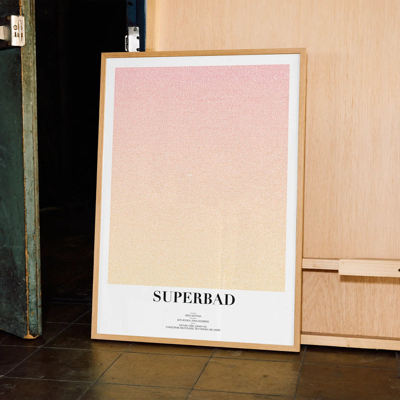 A framed Superbad movie script poster displayed in a contemporary interior setting.