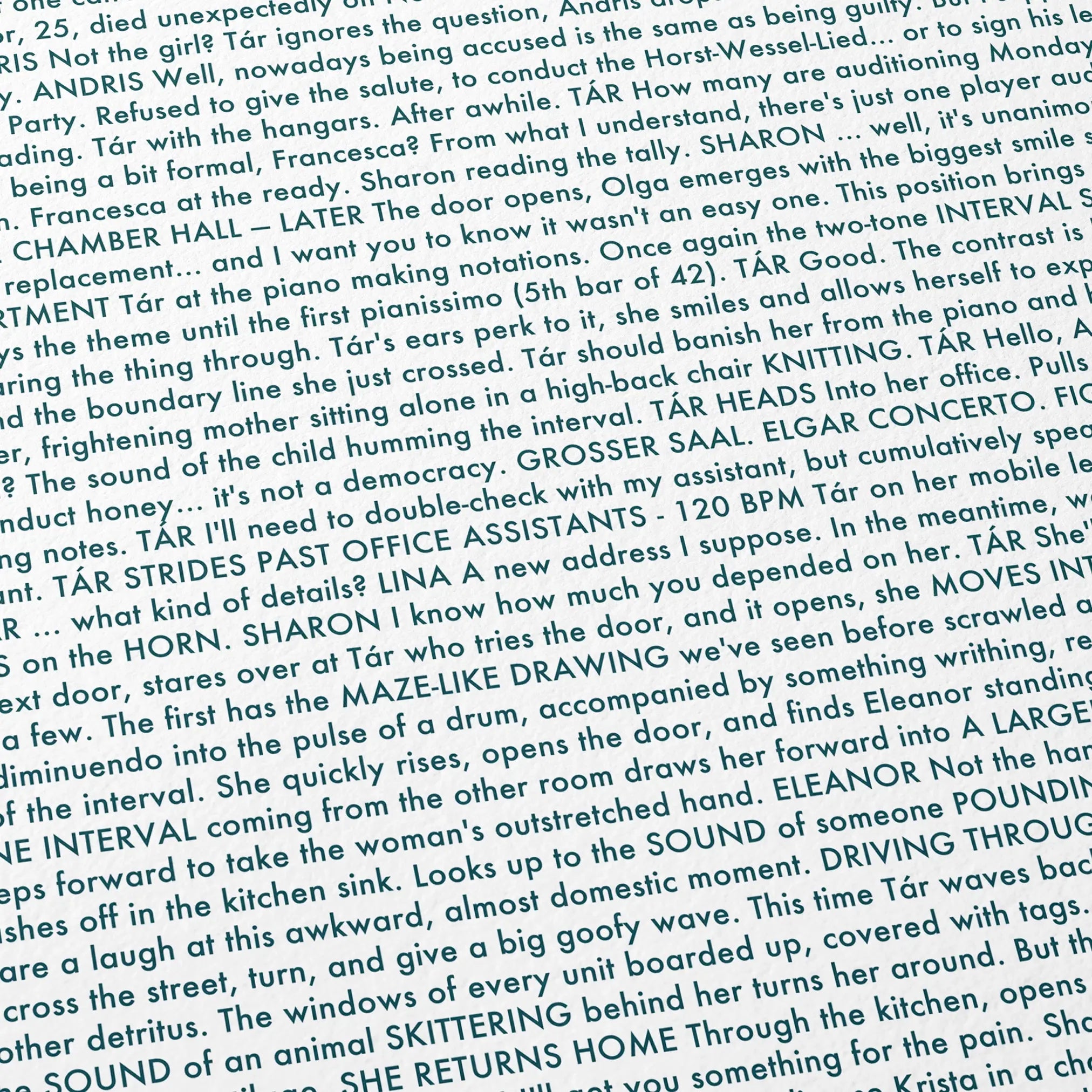 Close-up detail of the Tár movie script poster showing dense typographic text.