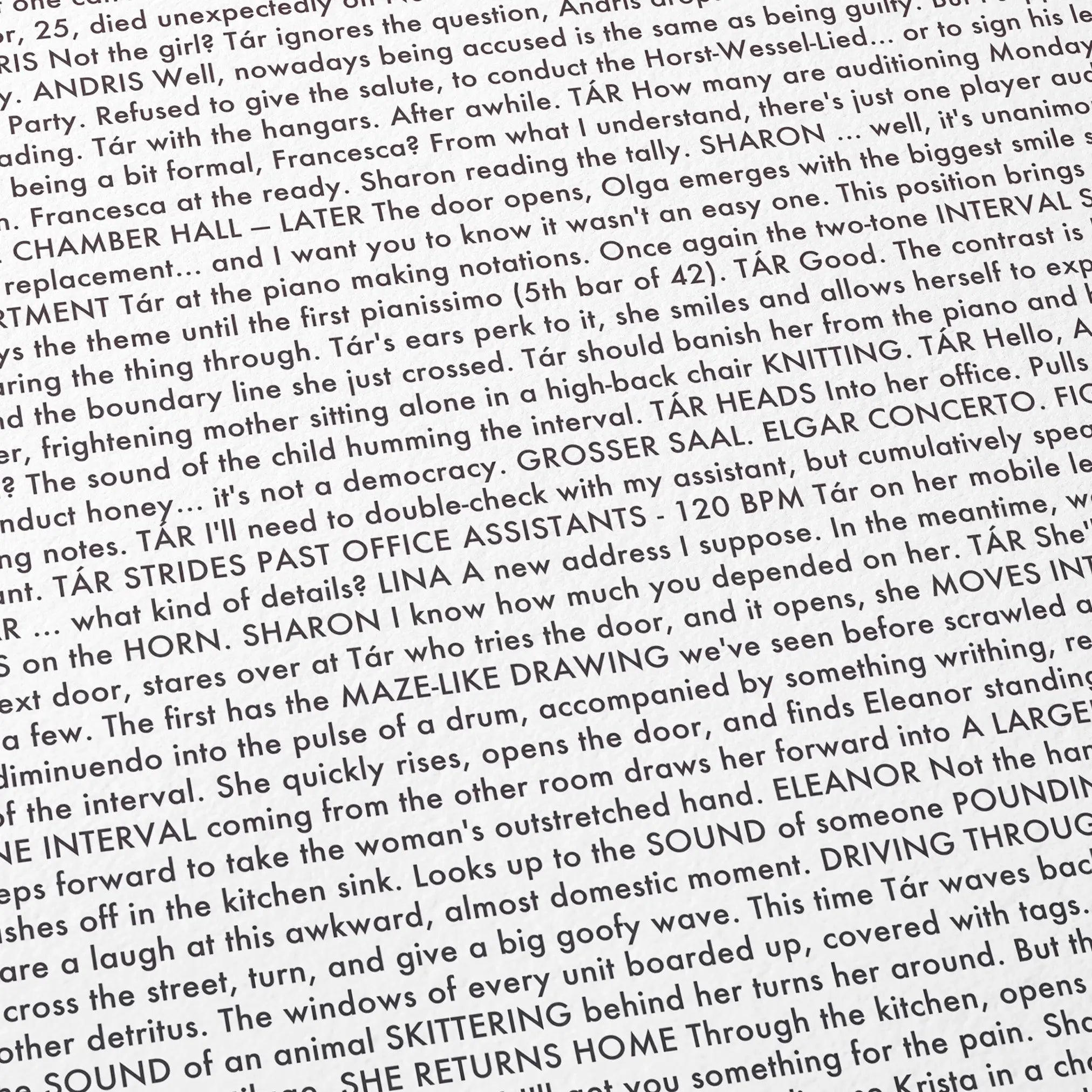 Close-up detail of the Tár movie script poster showing dense typographic text.
