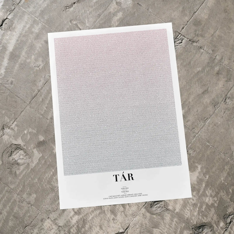 A Tár movie script poster laid flat on a textured floor surface.