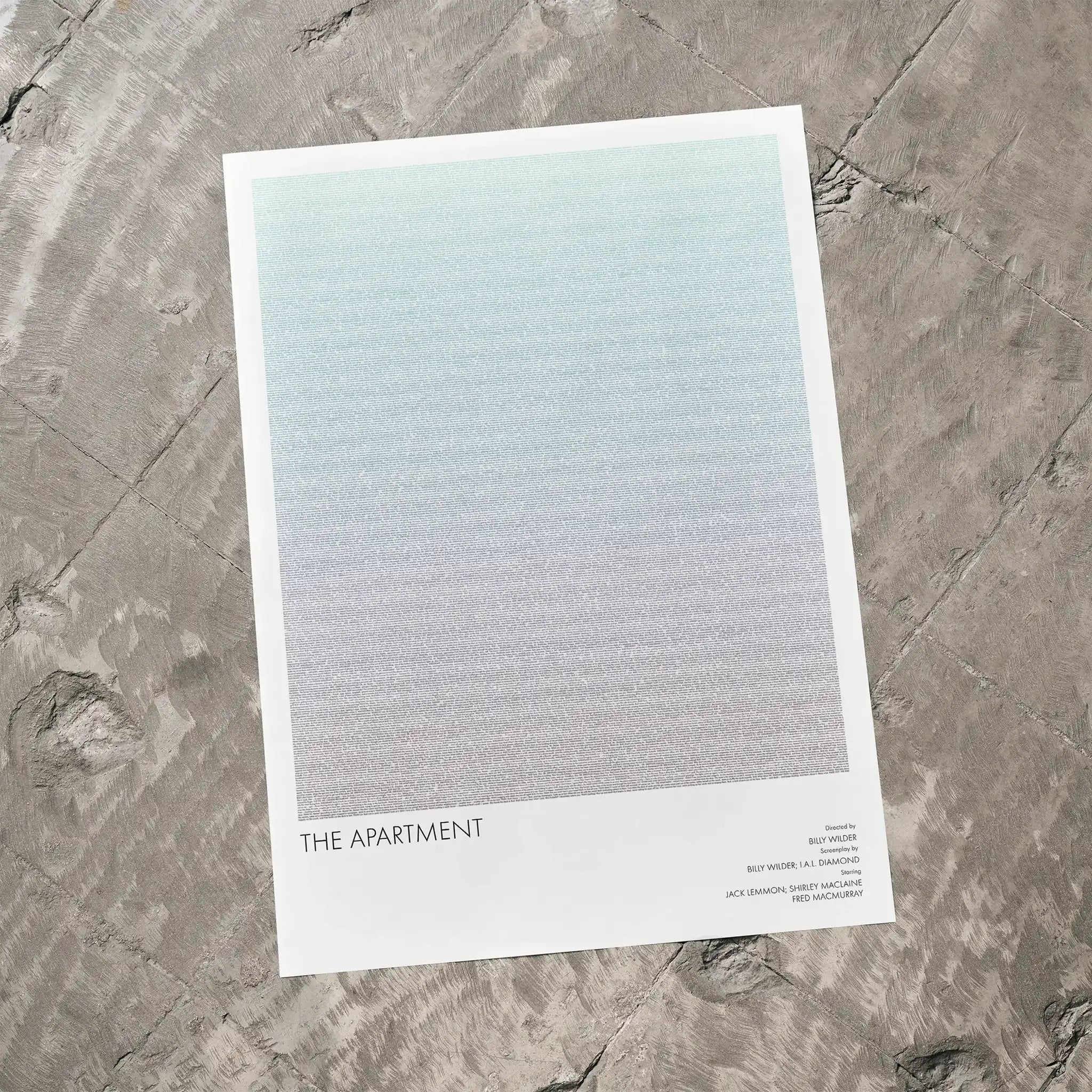 A The Apartment movie script poster laid flat on a textured floor surface.