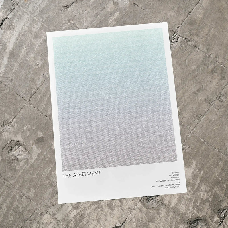 A The Apartment movie script poster laid flat on a textured floor surface.