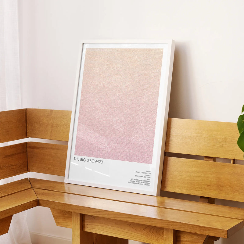 A framed The Big Lebowski movie script poster displayed on a sideboard in a contemporary space.