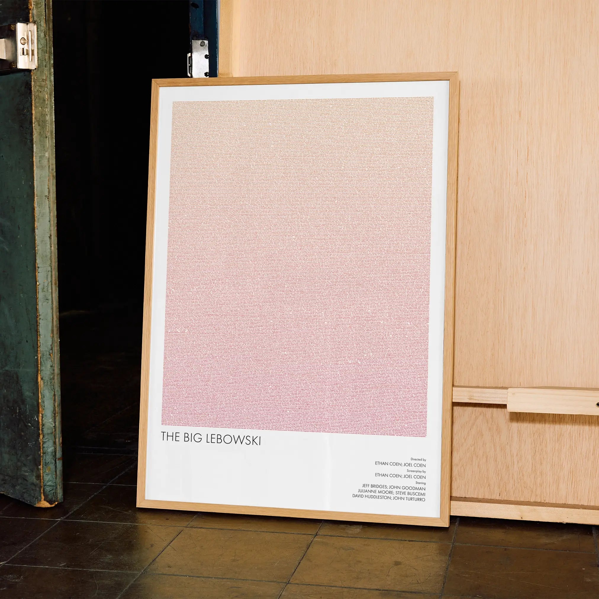 A framed The Big Lebowski movie script poster displayed in a contemporary interior setting.