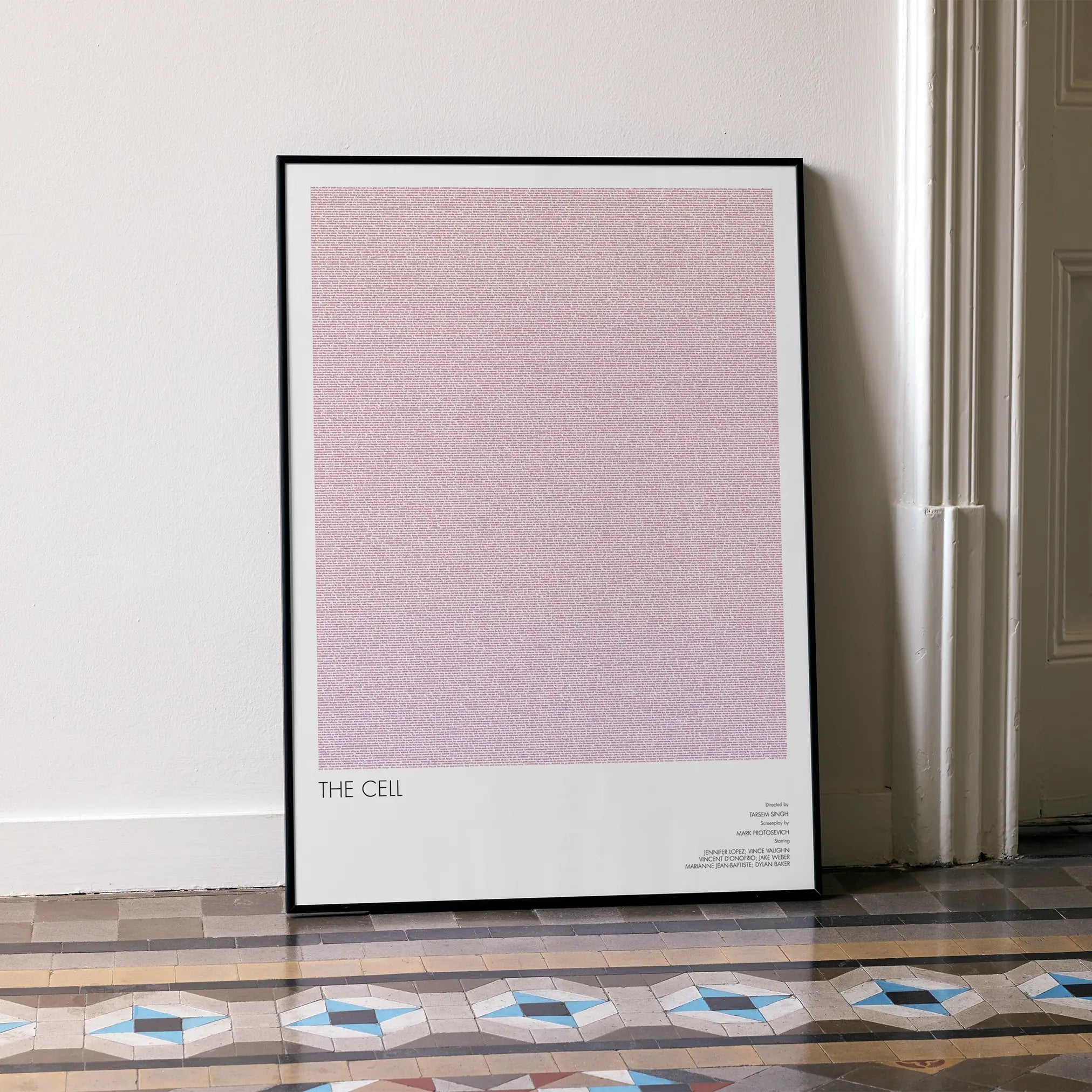 A framed The Cell movie script poster leaning against a wall in a minimalist interior.