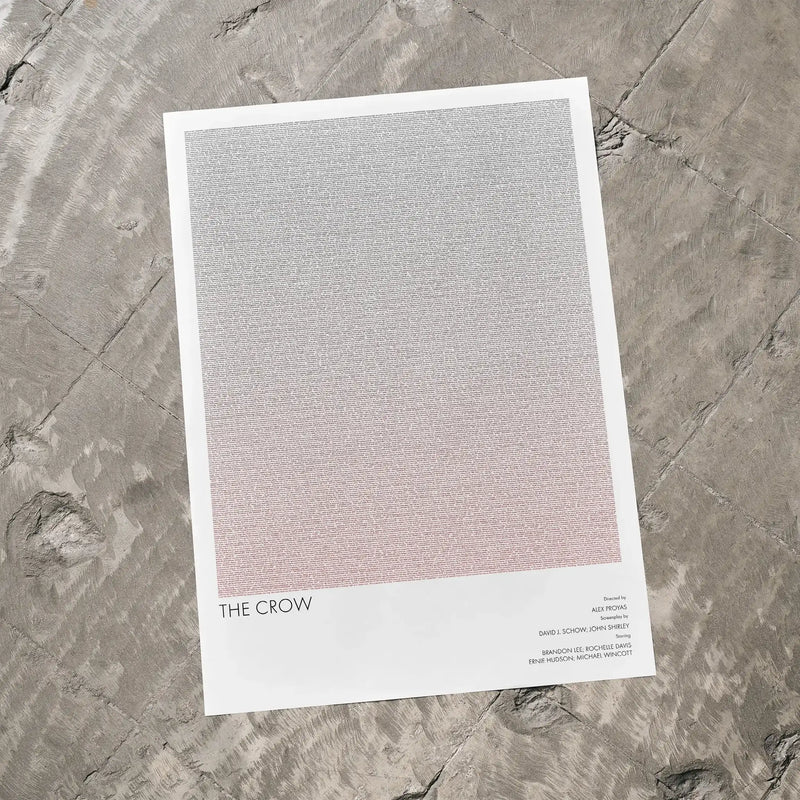 A The Crow movie script poster laid flat on a textured floor surface.