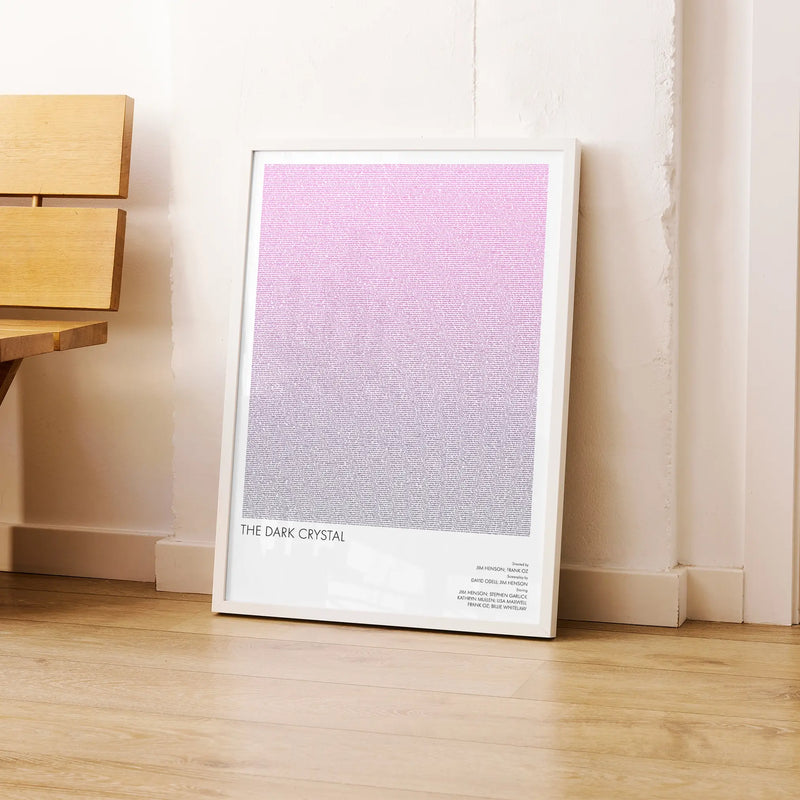 A framed The Dark Crystal movie script poster leaning against a wall in a modern interior.