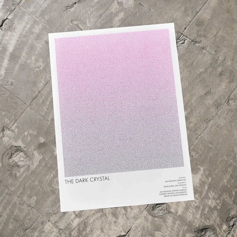 A The Dark Crystal movie script poster laid flat on a textured floor surface.