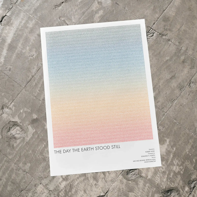 A The Day the Earth Stood Still movie script poster laid flat on a textured floor surface.