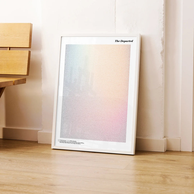 A framed The Departed movie script poster leaning against a wall in a modern interior.