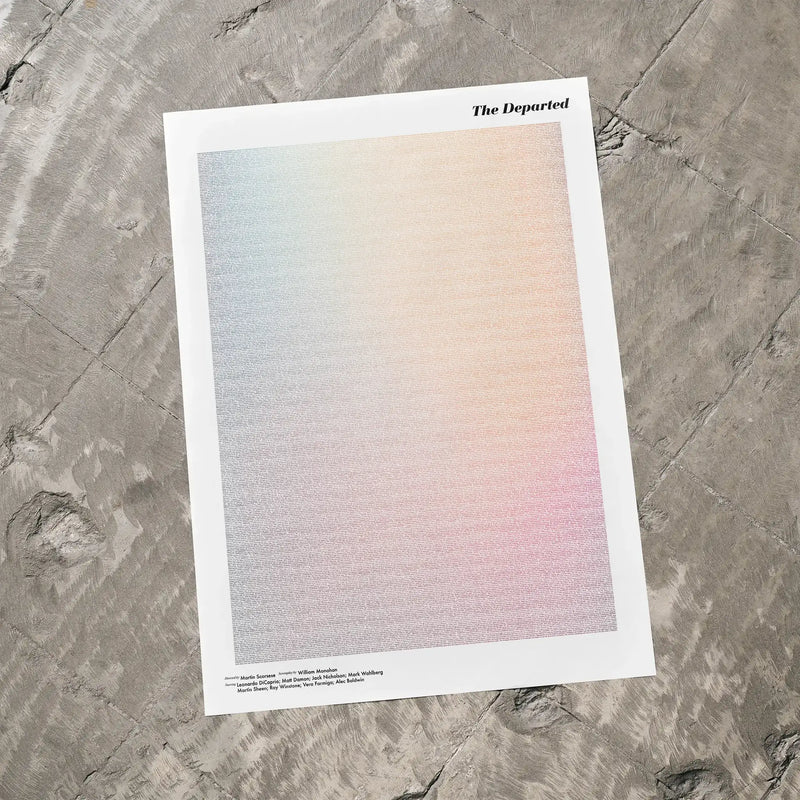 A The Departed movie script poster laid flat on a textured floor surface.