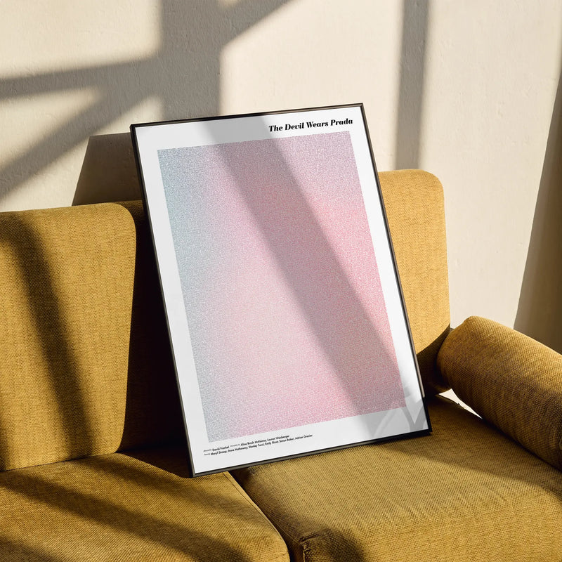 A framed The Devil Wears Prada movie script poster styled in a clean interior setting.