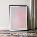 A framed The Devil Wears Prada movie script poster leaning against a wall in a minimalist interior.