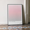 A framed The Devil Wears Prada movie script poster leaning against a wall in a minimalist interior.