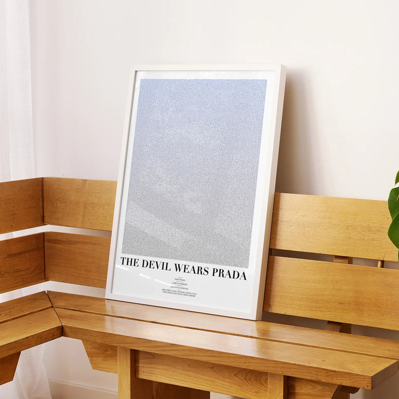 A framed The Devil Wears Prada movie script poster displayed on a sideboard in a contemporary space.