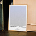 A framed The Devil Wears Prada movie script poster displayed in a contemporary interior setting.