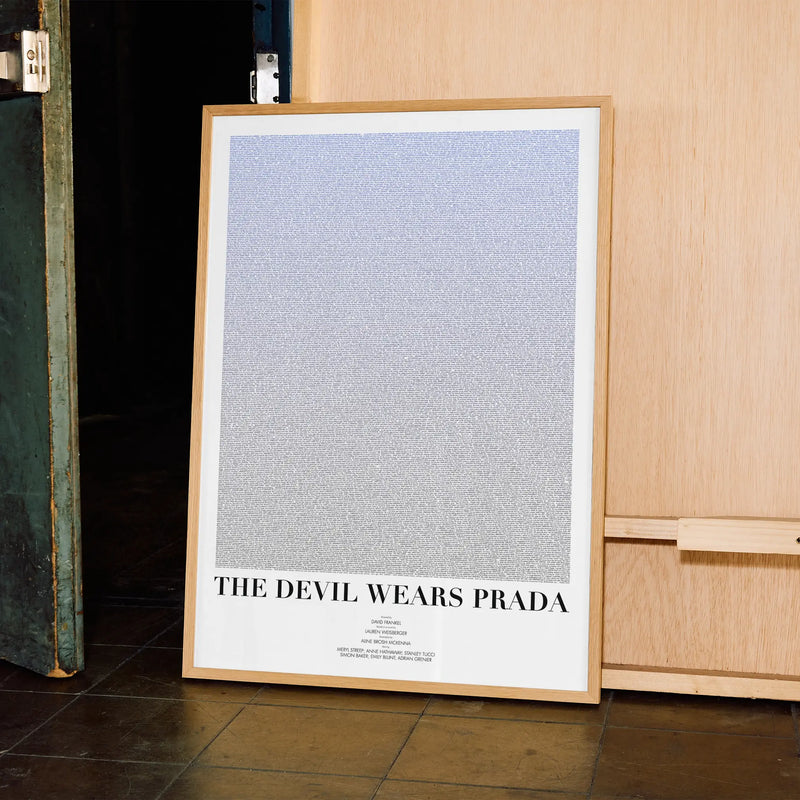 A framed The Devil Wears Prada movie script poster displayed in a contemporary interior setting.