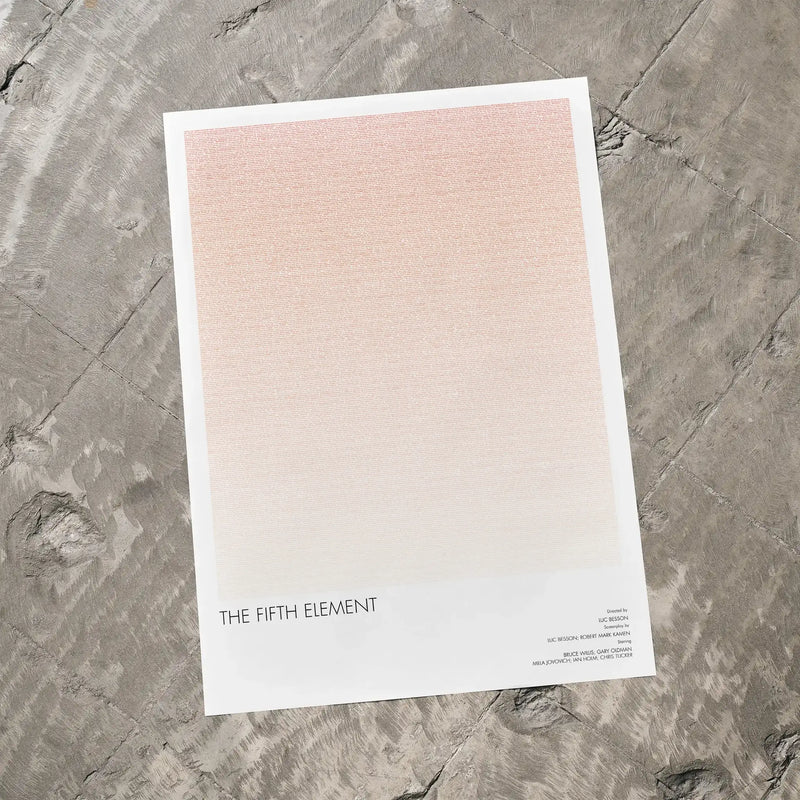 A The Fifth Element movie script poster laid flat on a textured floor surface.