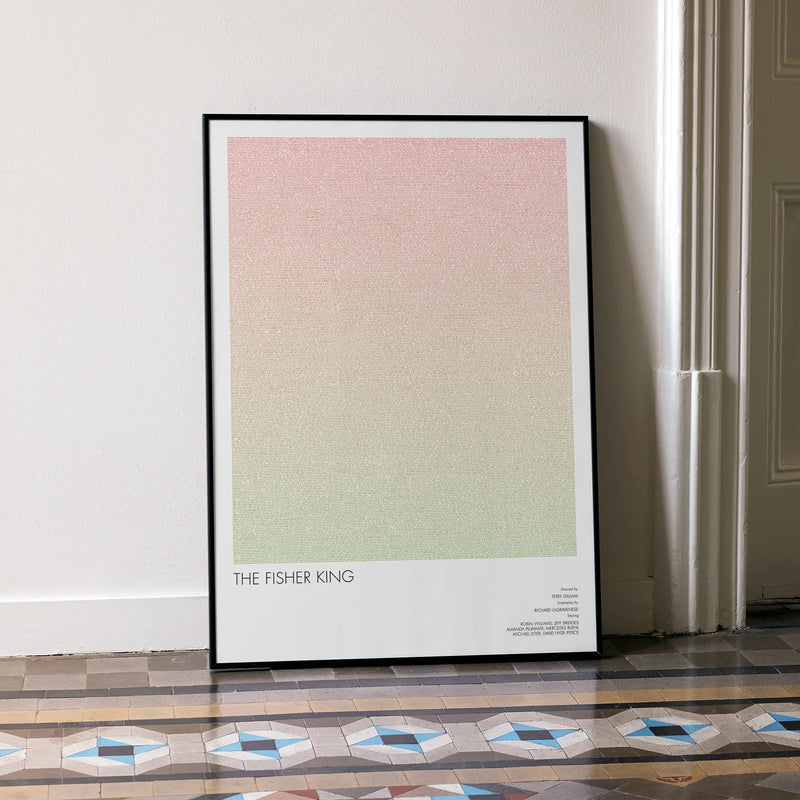 A framed The Fisher King movie script poster leaning against a wall in a minimalist interior.