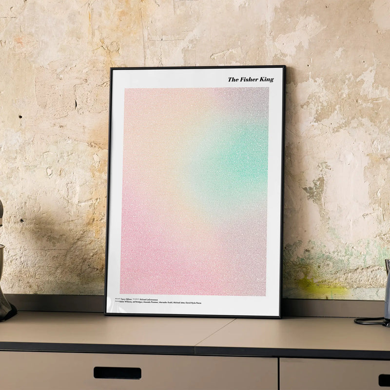 A framed The Fisher King movie script poster displayed on a cabinet in a minimalist interior.