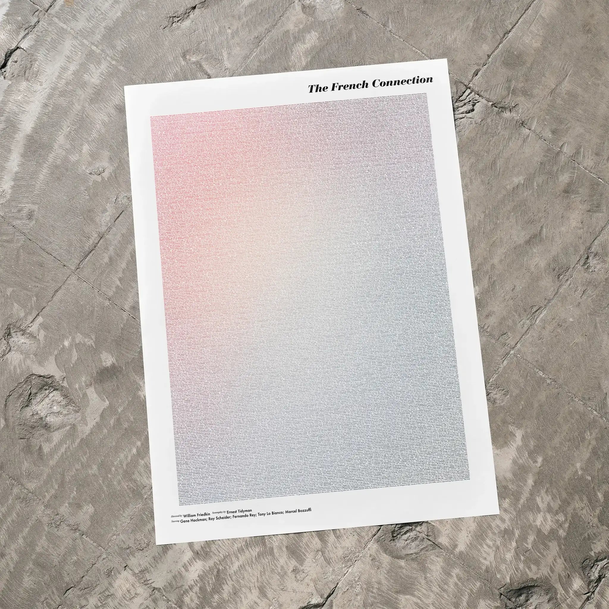 A The French Connection movie script poster laid flat on a textured floor surface.