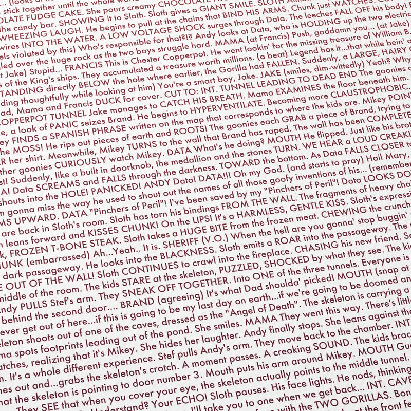 Close-up detail of the The Goonies movie script poster showing dense typographic text.