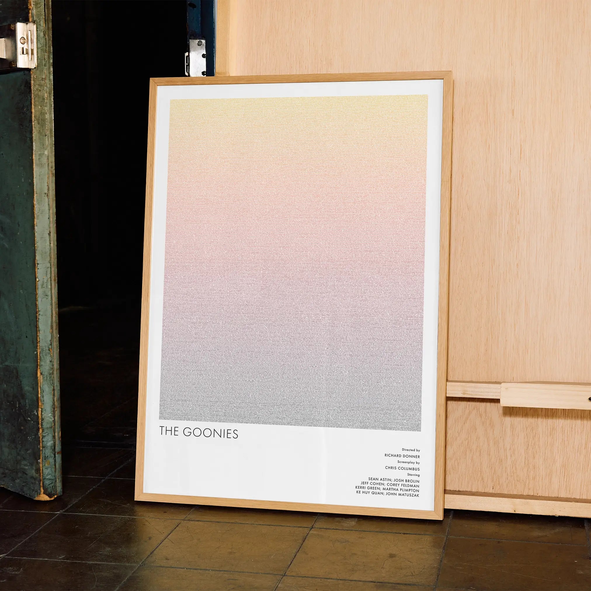 A framed The Goonies movie script poster displayed in a contemporary interior setting.