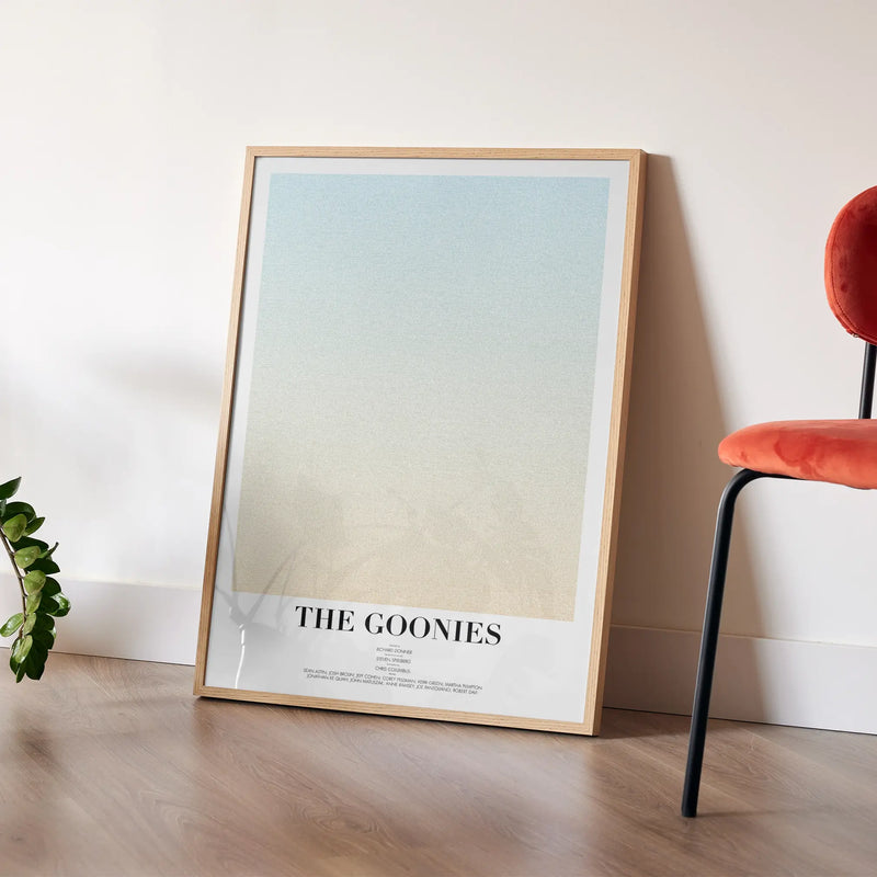 A framed The Goonies movie script poster styled in a clean interior setting.