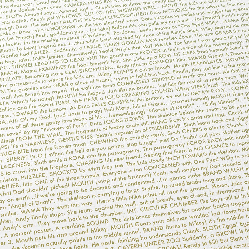 Close-up detail of the The Goonies movie script poster showing text.
