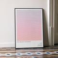 A framed The Greatest Showman movie script poster leaning against a wall in a minimalist interior.