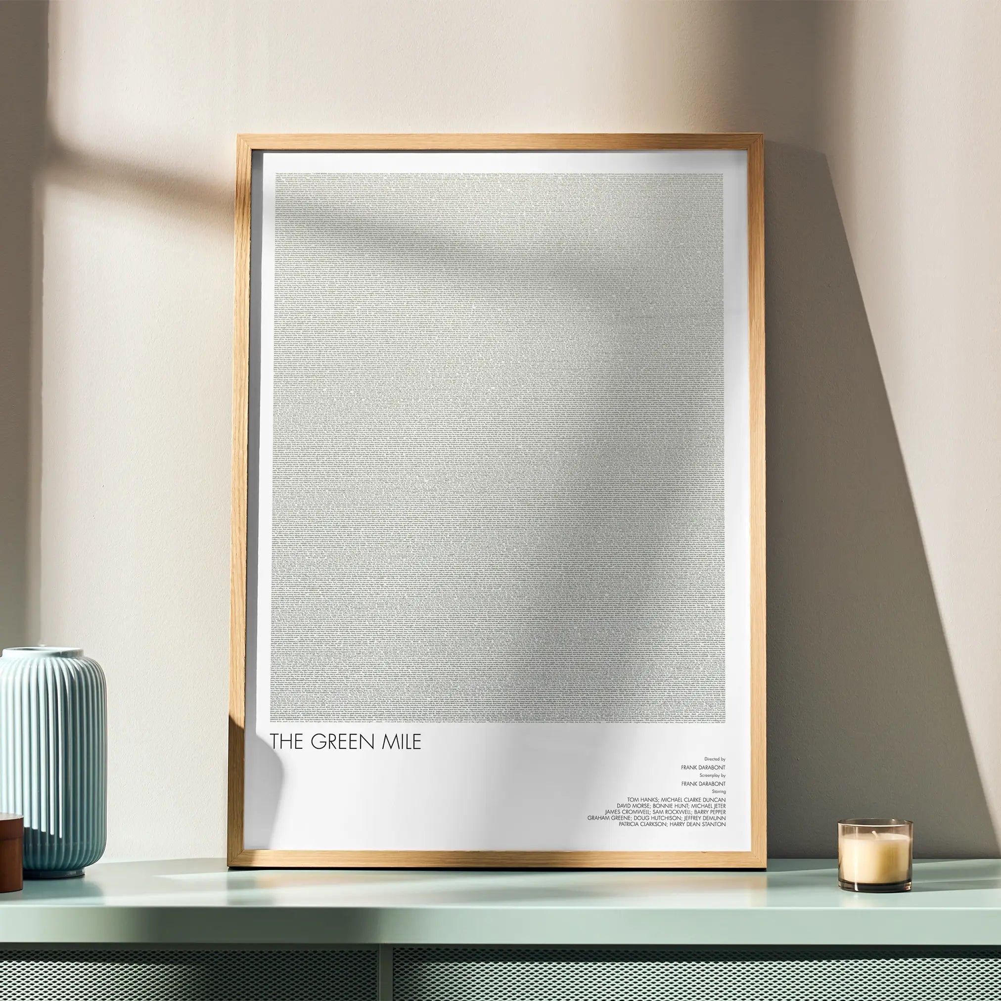 A framed The Green Mile movie script poster displayed in a simple modern interior.