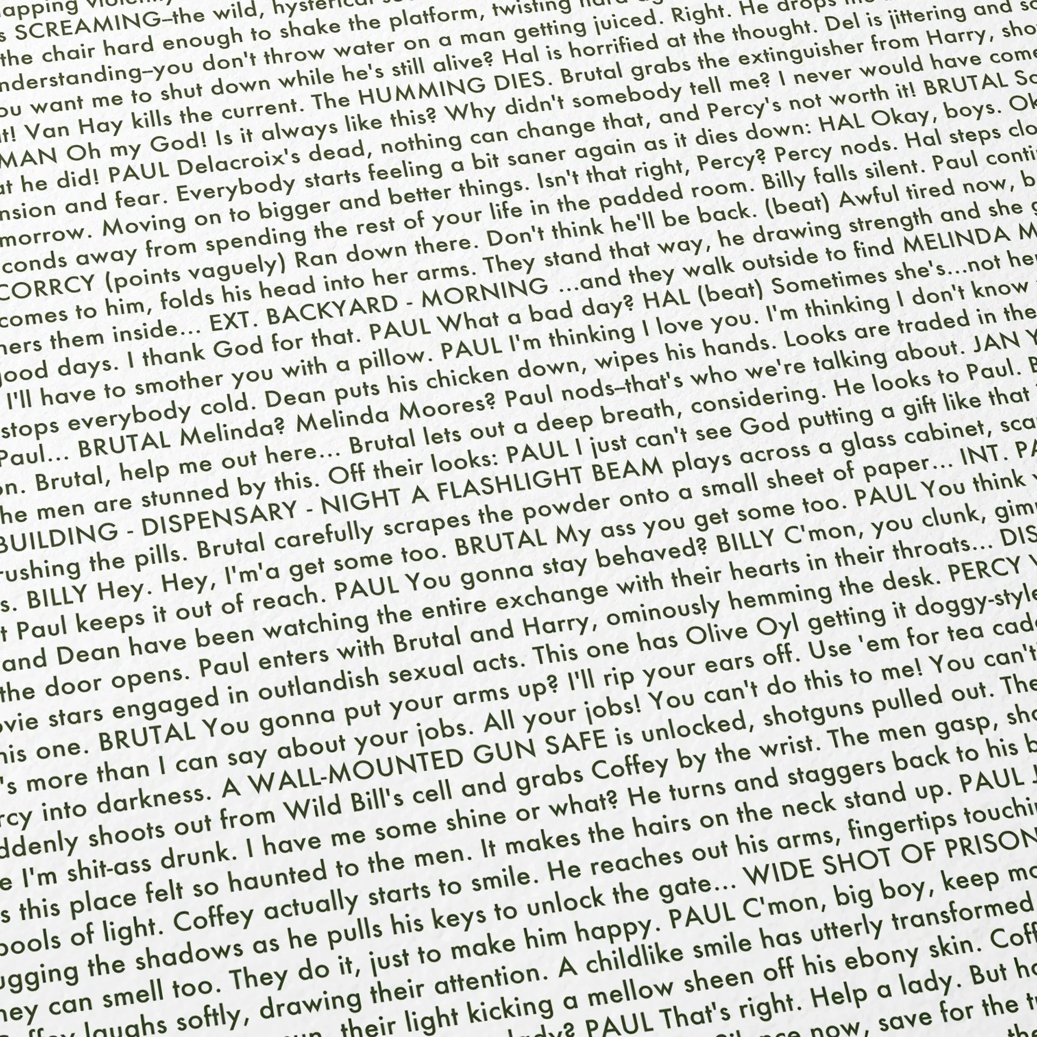 Close-up detail of the The Green Mile movie script poster showing dense typographic text.