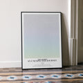 A framed The Hobbit: An Unexpected Journey movie script poster leaning against a wall in a minimalist interior.