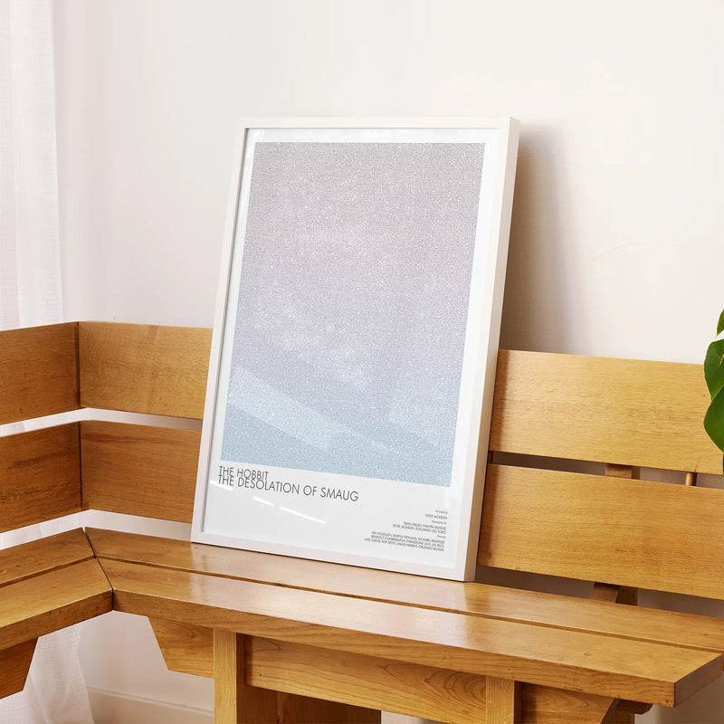 A framed The Hobbit: The Desolation of Smaug movie script poster displayed on a sideboard in a contemporary space.