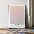 A framed The Hobbit: The Desolation of Smaug movie script poster leaning against a wall in a minimalist interior.