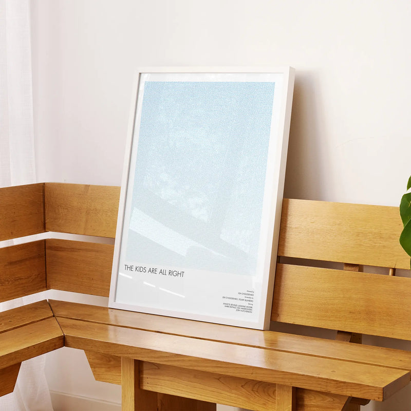 A framed The Kids Are All Right movie script poster displayed on a sideboard in a contemporary space.