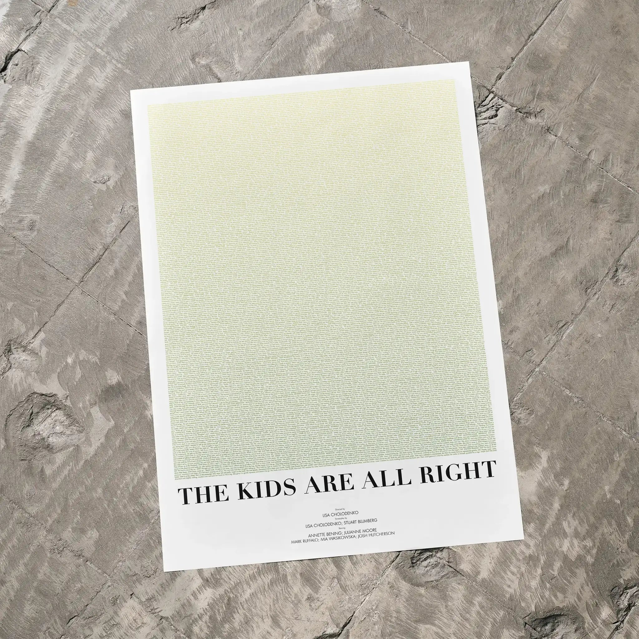 A The Kids Are All Right movie script poster laid flat on a textured floor surface.