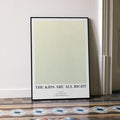 A framed The Kids Are All Right movie script poster leaning against a wall in a minimalist interior.