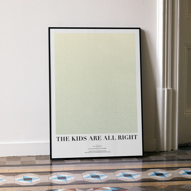 A framed The Kids Are All Right movie script poster leaning against a wall in a minimalist interior.
