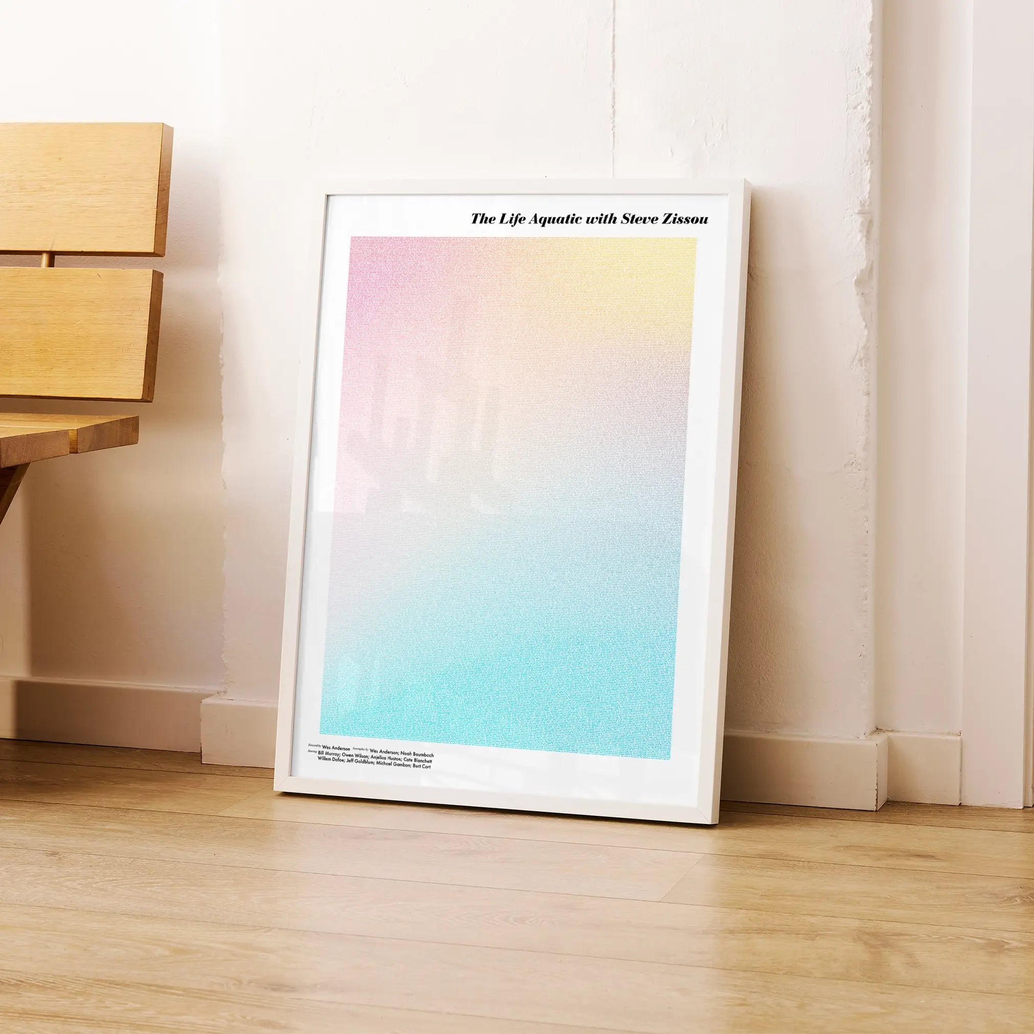 A framed The Life Aquatic with Steve Zissou movie script poster leaning against a wall in a modern interior.