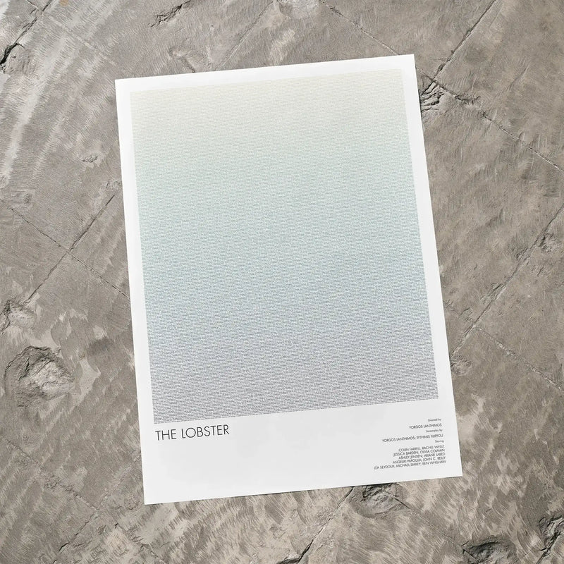A The Lobster movie script poster laid flat on a textured floor surface.