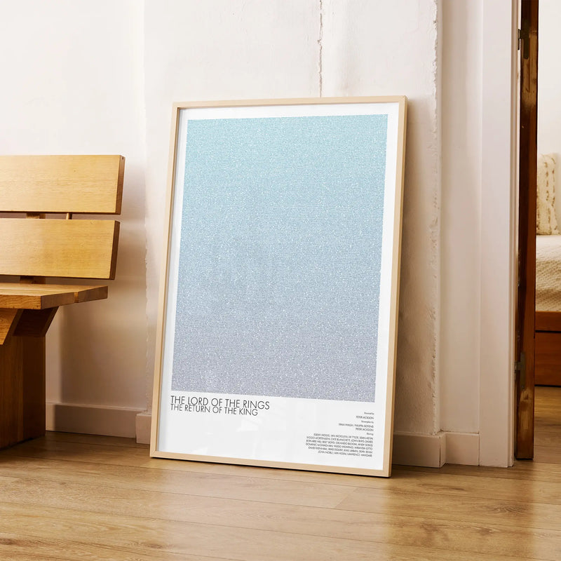 A framed The Lord of the Rings: The Return of the King movie script poster arranged in a minimalist interior setting.