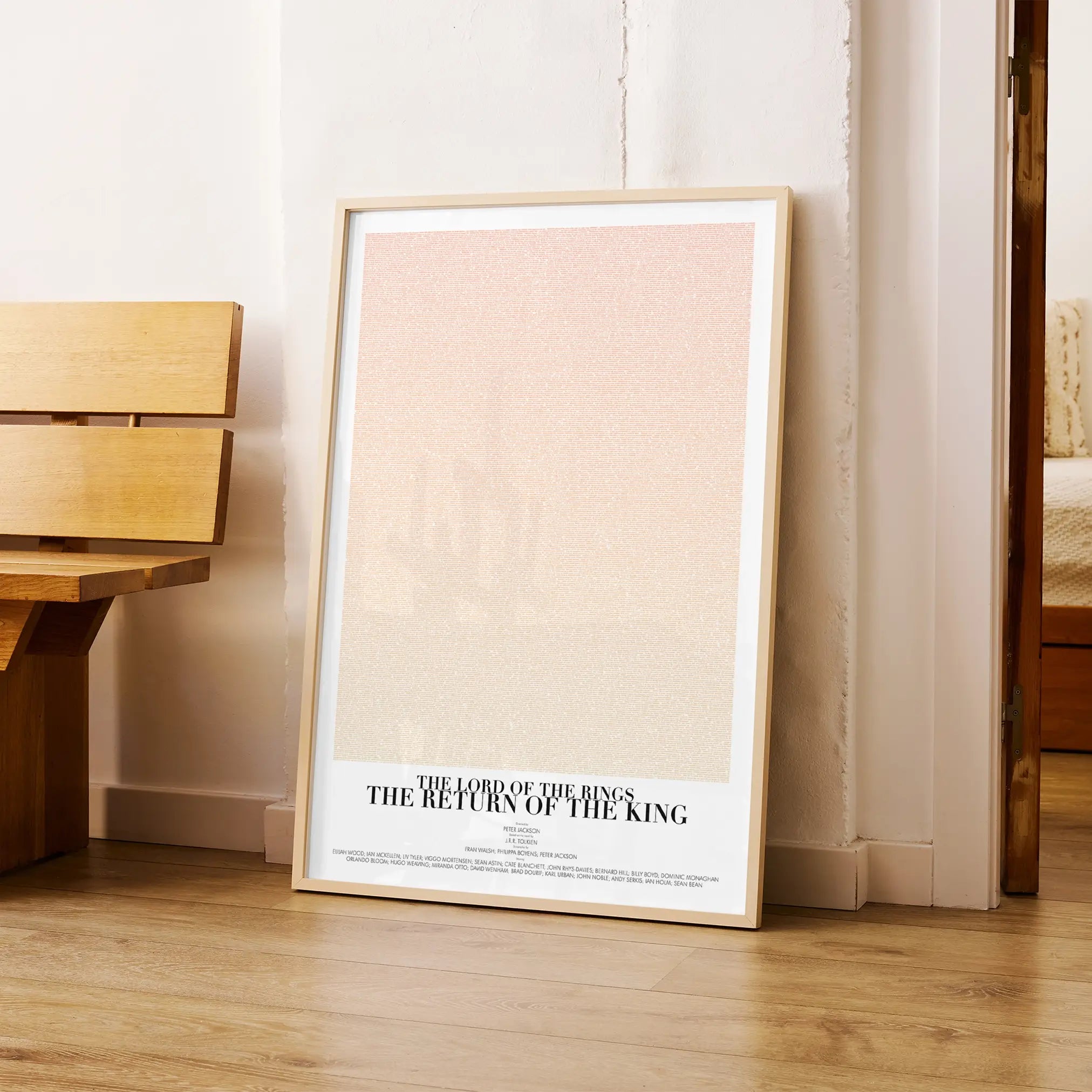 A framed The Lord of the Rings: The Return of the King movie script poster arranged in a minimalist interior setting.