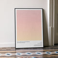 A framed The Lord of the Rings: The Two Towers movie script poster leaning against a wall in a minimalist interior.