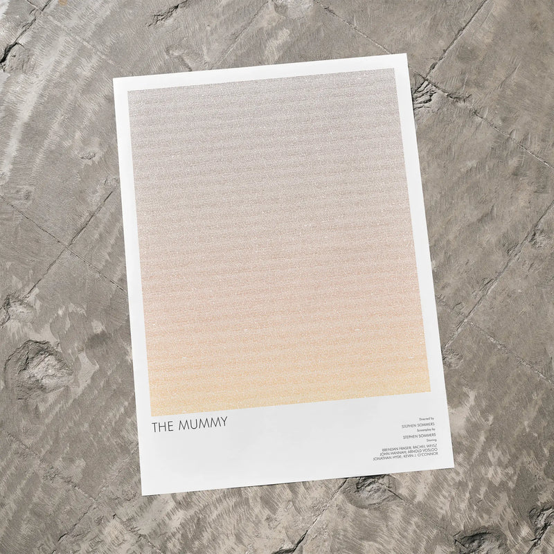 A The Mummy movie script poster laid flat on a textured floor surface.