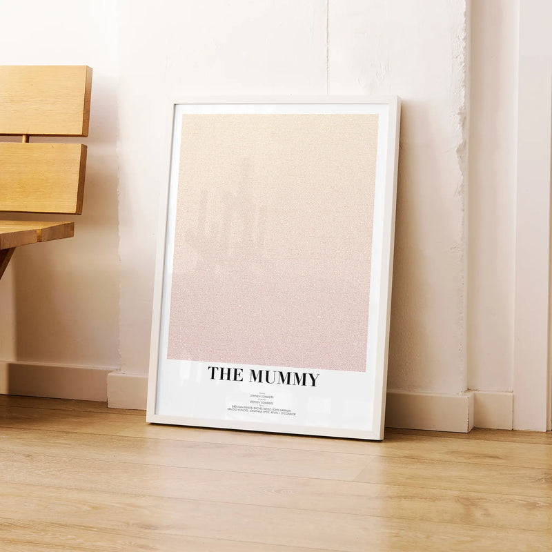 A framed The Mummy movie script poster leaning against a wall in a modern interior.