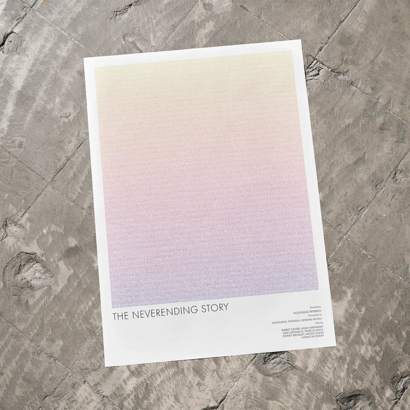 A The NeverEnding Story movie script poster laid flat on a textured floor surface.