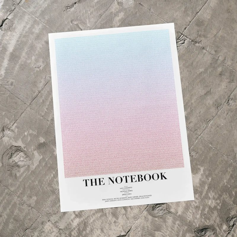 A The Notebook movie script poster laid flat on a textured floor surface.