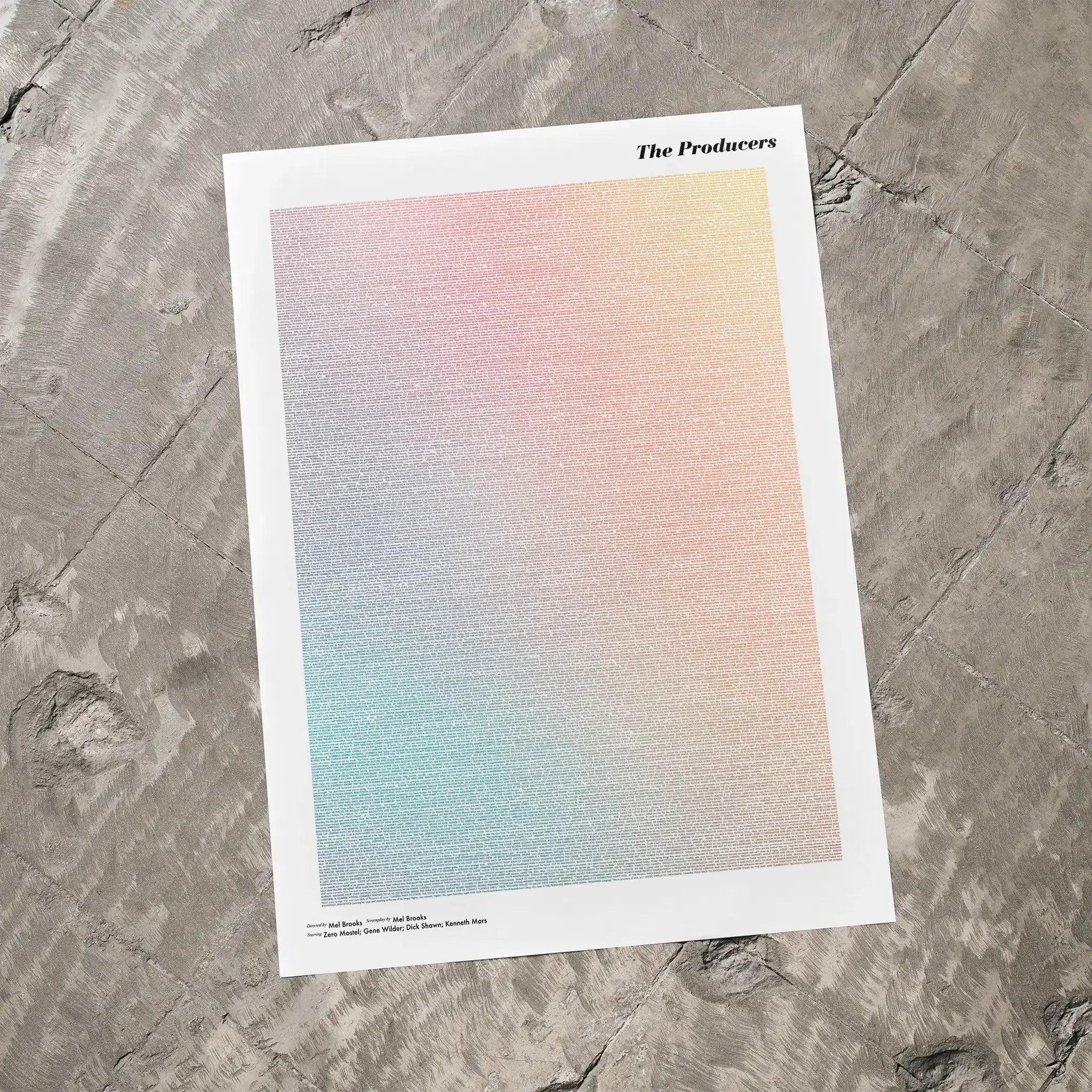 A The Producers movie script poster laid flat on a textured floor surface.